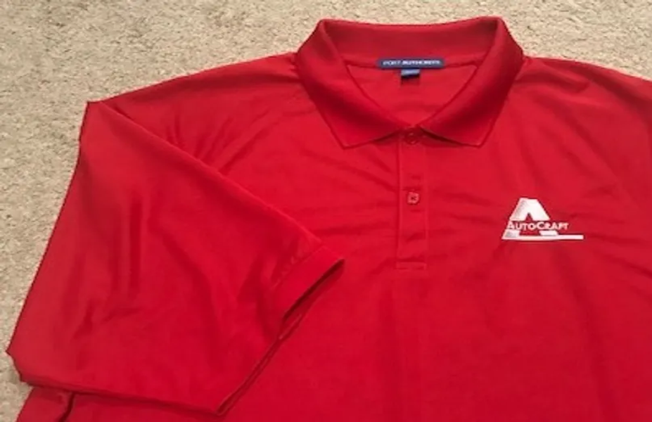 Red polo shirt with a small logo on the chest pocket area.