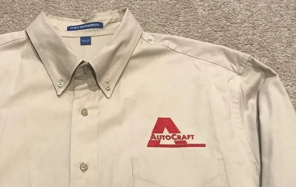 Beige button-up shirt with Autocraft logo on the chest pocket.