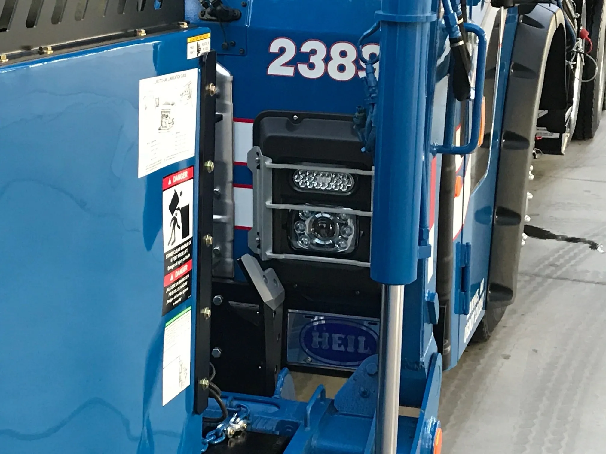 Close-up of blue industrial machinery with labels and controls.