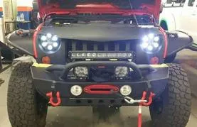 Front view of a rugged off-road vehicle with bright LED headlights and a sturdy bumper.