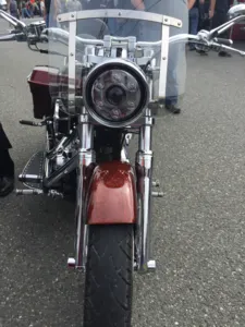 Front view of a classic motorcycle with a large round headlight.