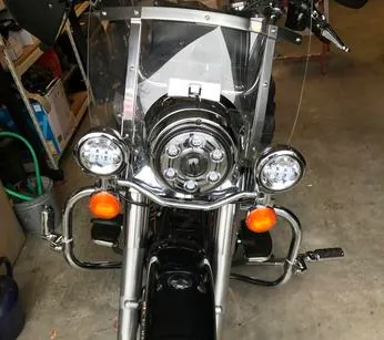 Front view of a classic motorcycle with headlights and windshield.